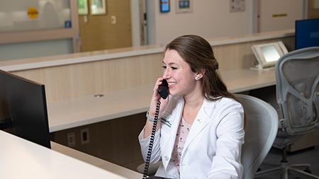 Desk receptionist on phone